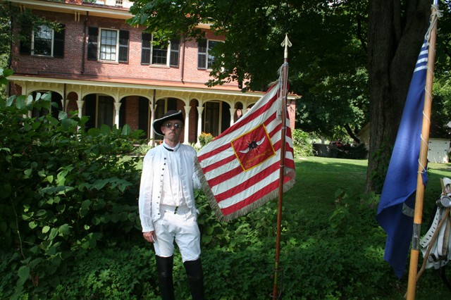 Ralph Whitney with the authorized replica of the battle flag of the Continental Army's 2nd Light Dragoons. The original sold for $11 million at auction.